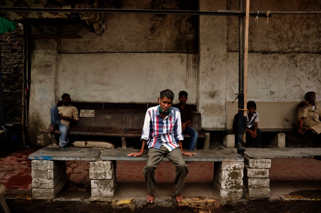 Photo of Indian men waiting at a bus junction in India.