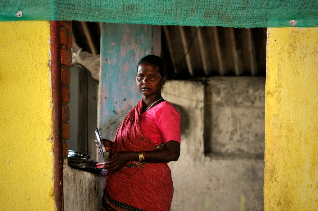 Photo of a woman in a small restaurant in India.