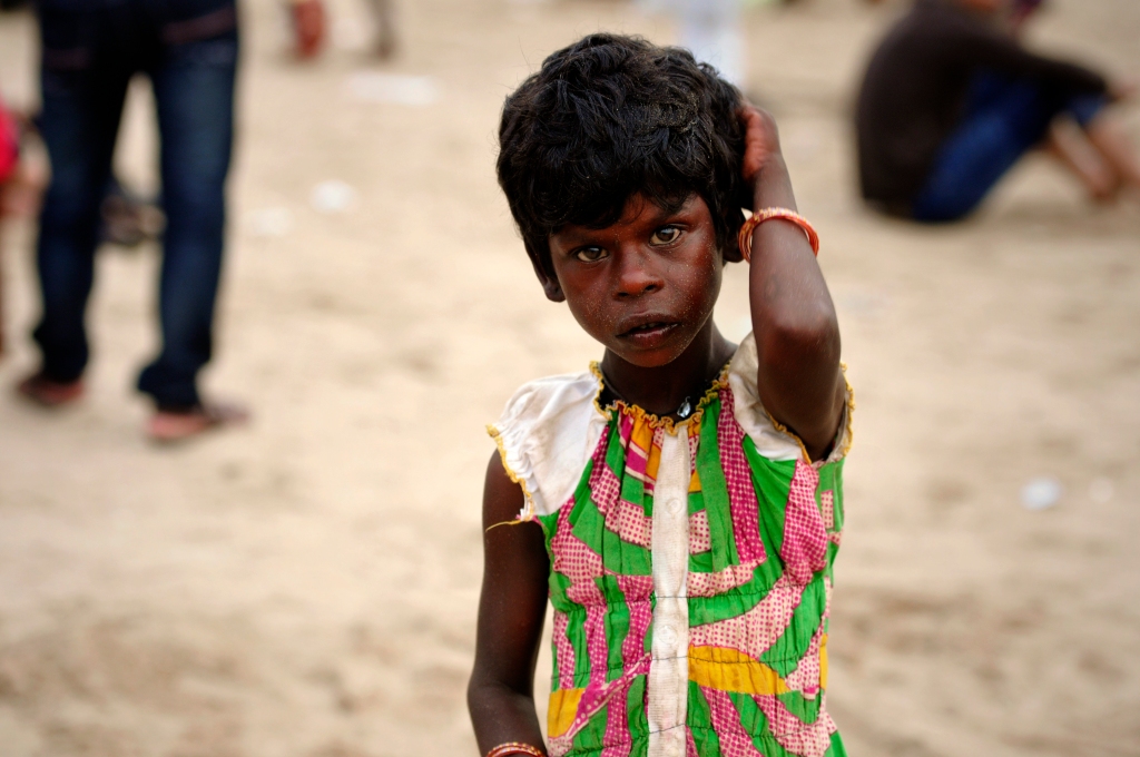 Photo of a beggar girl at the Juhu Beach in India.