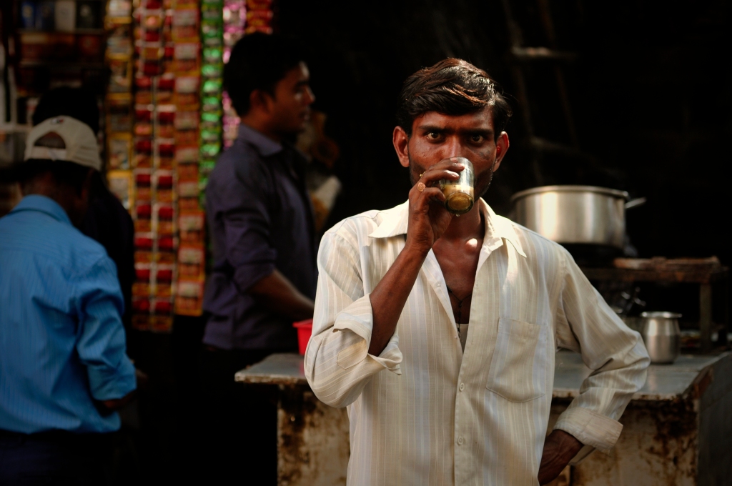 Photo of a man drinking chai tea in India.