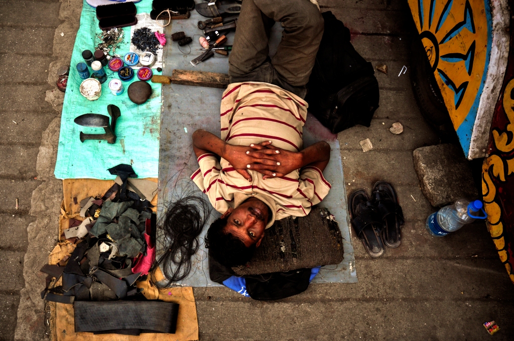 Photo of a shoe polisher in India.