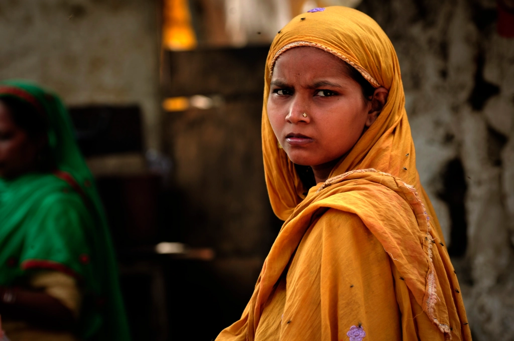 Photo of an Indian girl in a yellow sari in India.