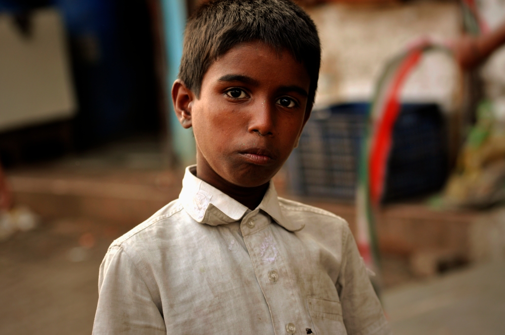 Photo of a boy in a street in Dharavi in India.
