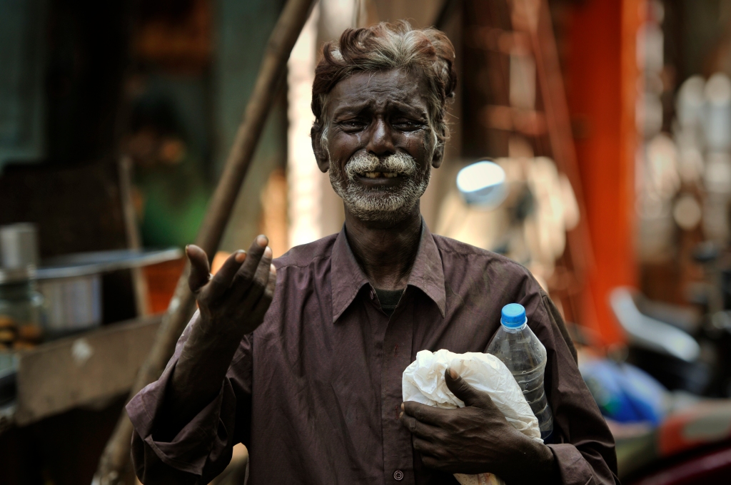Photo of sad and crying man in India.