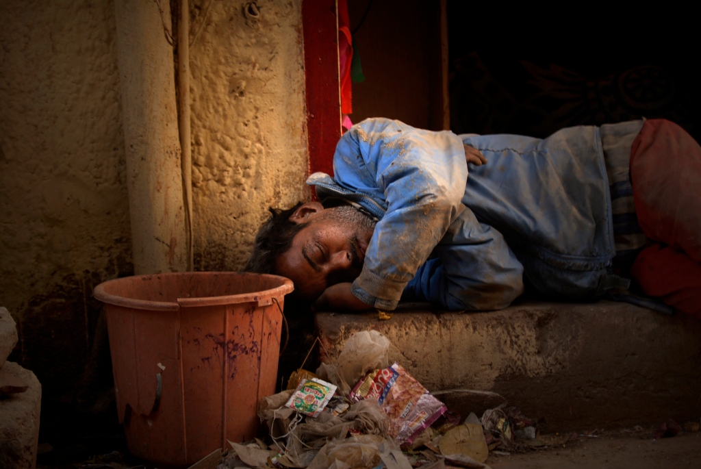 Photo of a sleeping man at Arakashan Rd in Delhi, India.