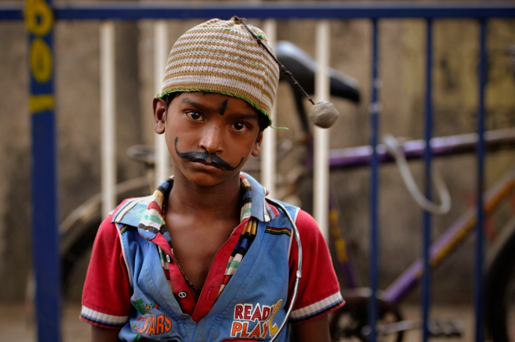 Photo of a boy in Mumbai, India. India beggar portrait in India.